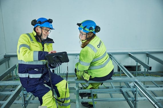 Two workers looking at electrical plans (R0A6266).jpg